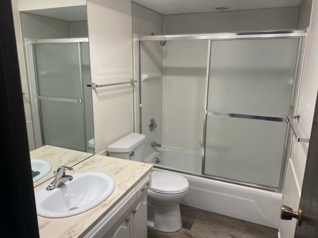 A bathroom with a toilet, sink, and shower.