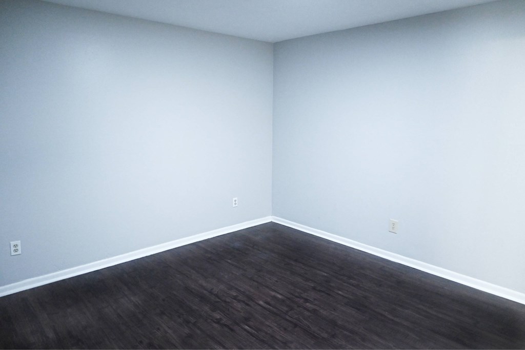 A room with a wooden floor and white walls.