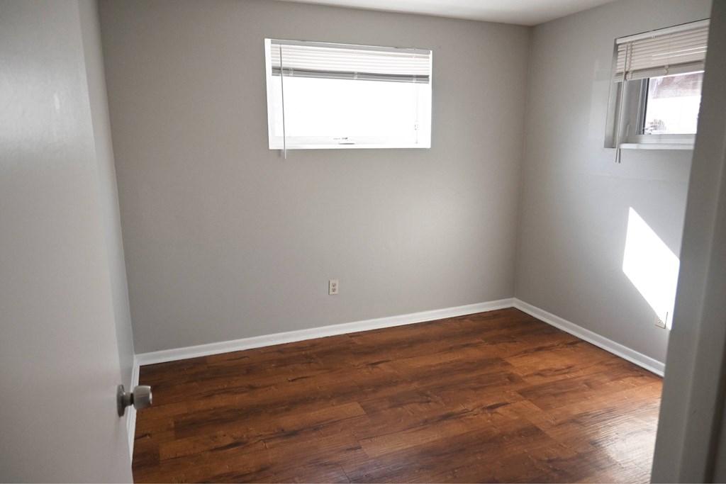 A room with wooden floors and a window.