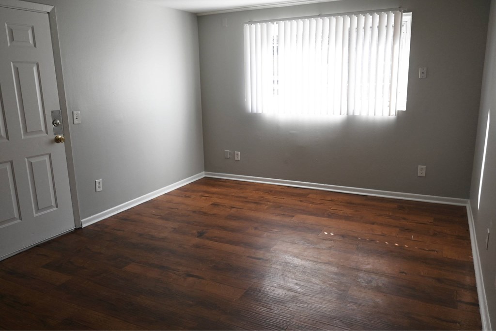 A room with wooden floors and a white door.