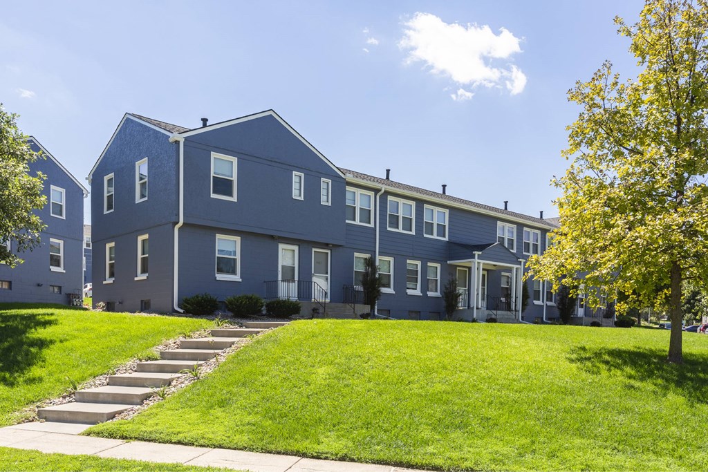 A blue building with a white door and windows.