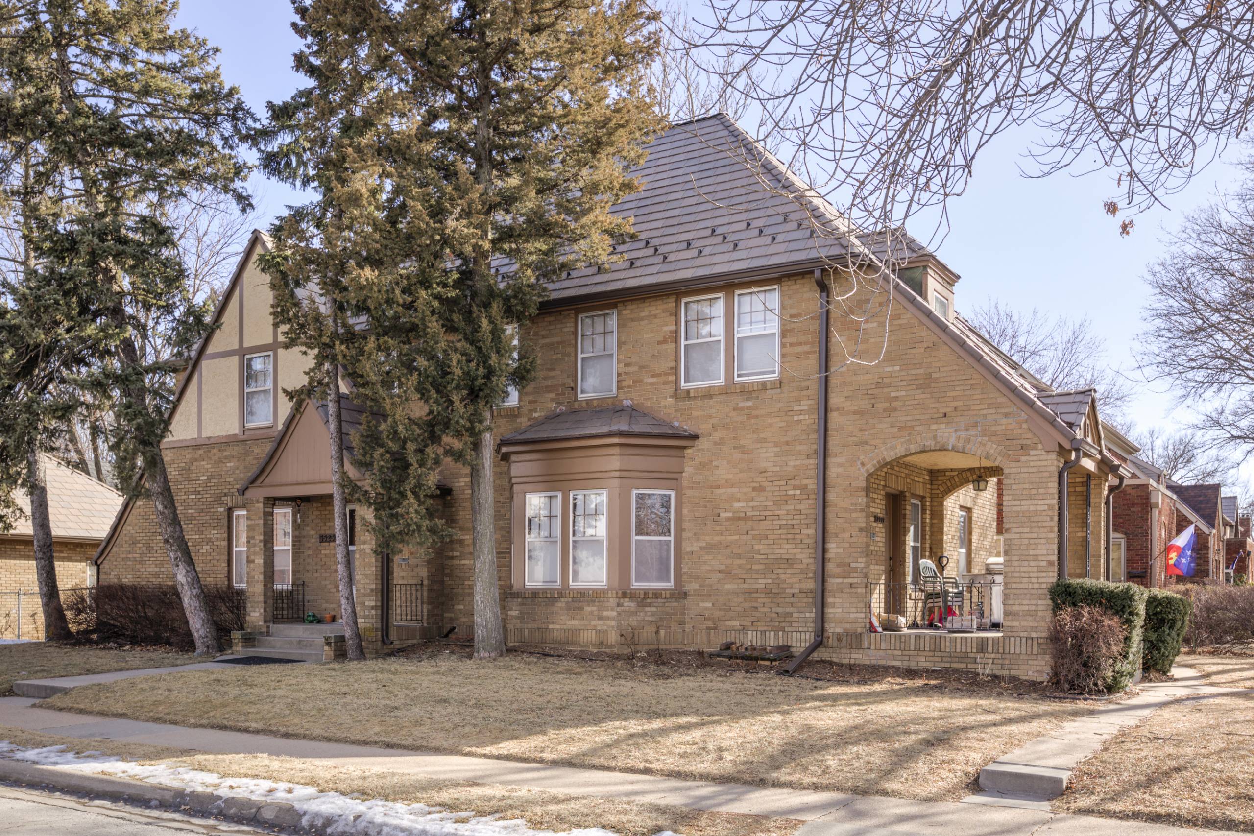 A house with a brown brick exterior and a grey roof.