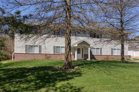 A house with a tree in front of it.