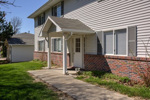 A house with a white door and a small porch.