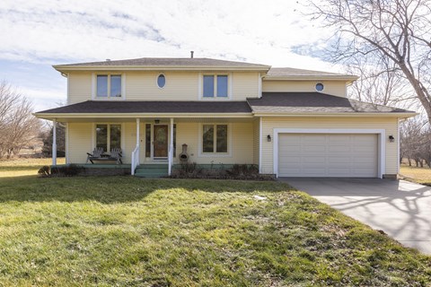 A two-story house with a garage on the right side.