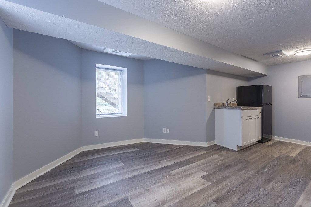 A room with a window and a cabinet.