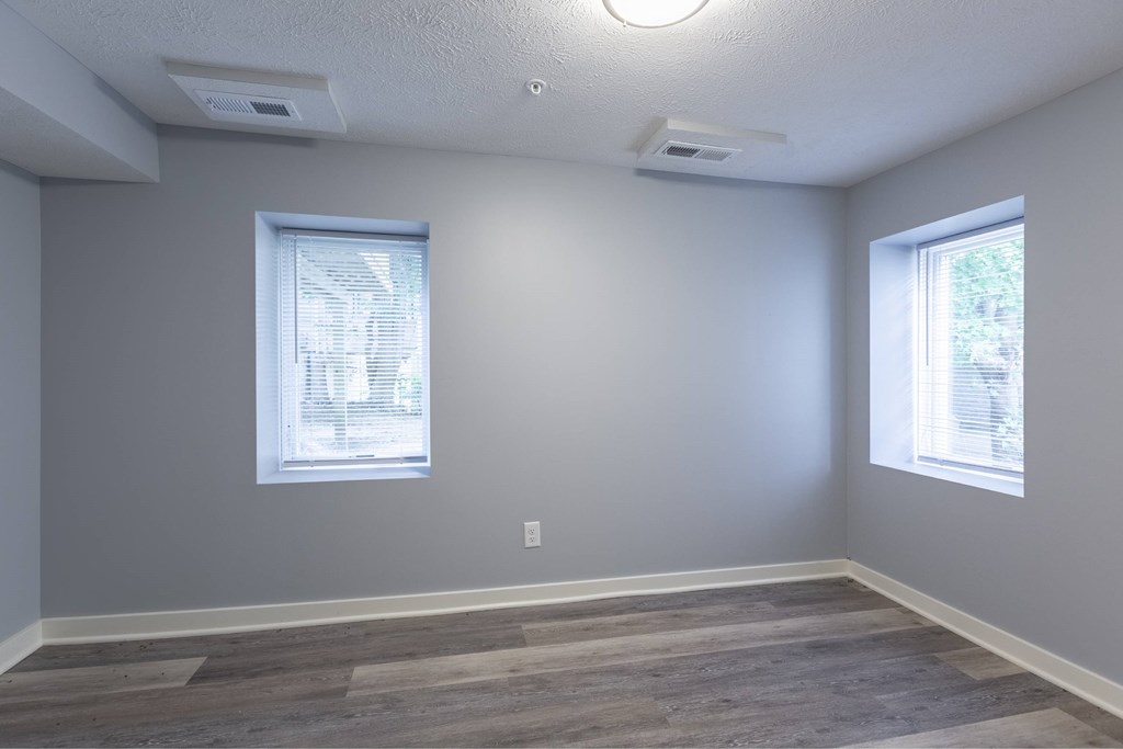 A room with grey walls and wooden flooring.
