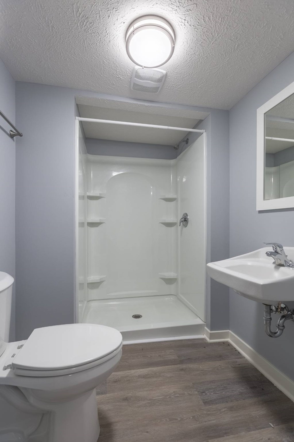 A white toilet sits next to a sink in a bathroom.