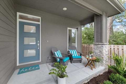 A house with a blue door and a small porch.