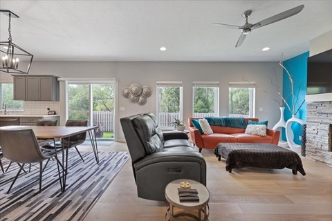 A modern living room with a dining table and chairs.