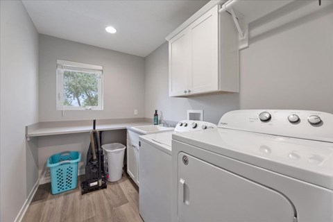 A white washing machine and dryer in a laundry room.