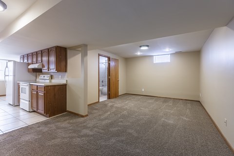 A kitchen with white appliances and brown cabinets is shown.