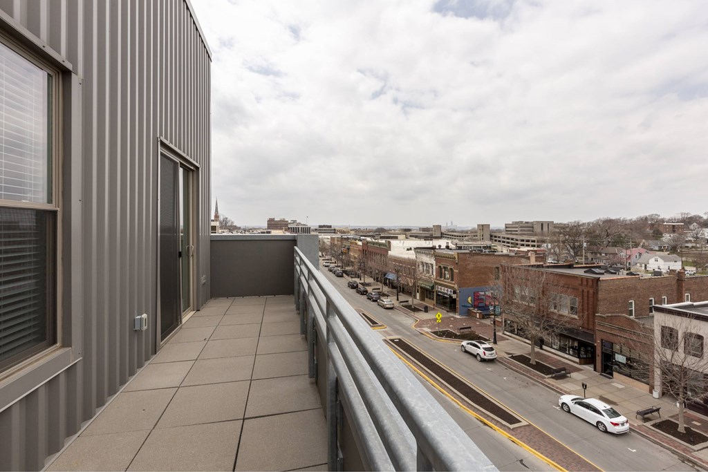 A view from a balcony overlooking a city street.