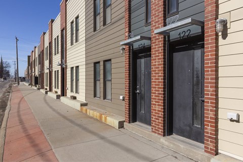 A row of townhouses with numbers 404 and 122 on the front.