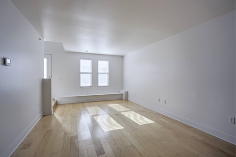 A room with wooden floors and white walls.