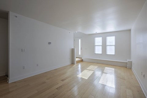 A room with wooden floors and white walls.