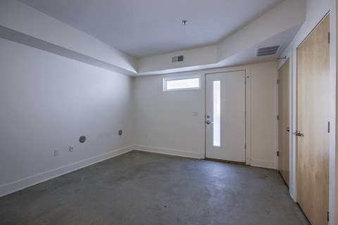 A room with a window, two doors, and a ceiling fan.