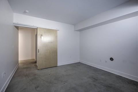 A room with a door and a wall socket.