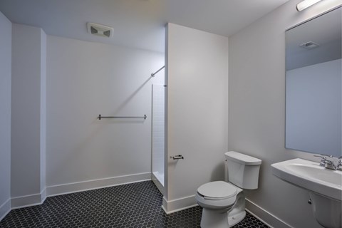 A white toilet sits next to a sink in a small bathroom.