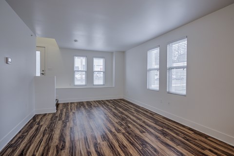 A room with wooden floors and white walls.