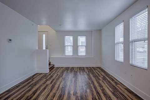 A room with wooden floors and white walls.
