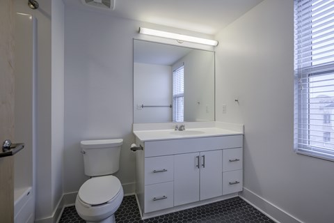 A white toilet sits next to a sink in a bathroom.