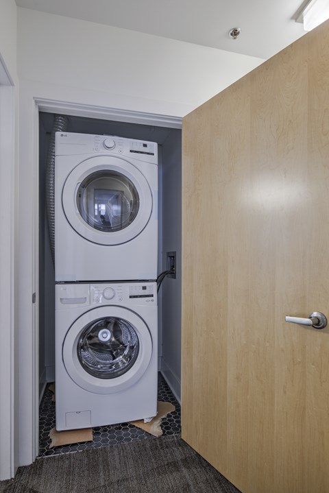 A washing machine is in a doorway.