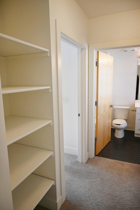 A white door is open to a bathroom.