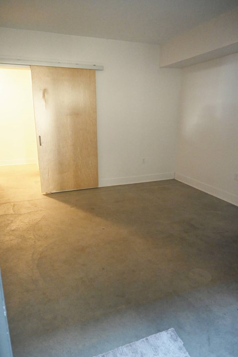 A room with a brown door and a brown floor.