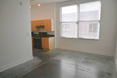 A kitchen with black appliances and wooden cabinets.