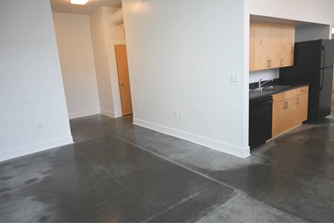 A kitchen with black appliances and wooden cabinets.