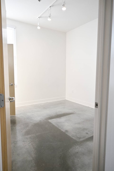 A room with a concrete floor and white walls.