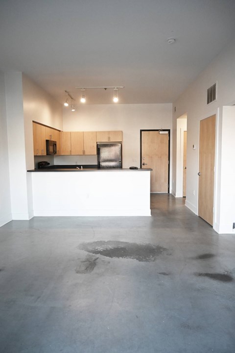 A kitchen area with a counter and cabinets.