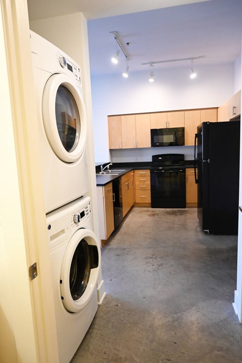 A white washing machine is in a doorway.