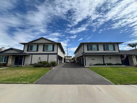 A row of houses with a flag on the right one.
