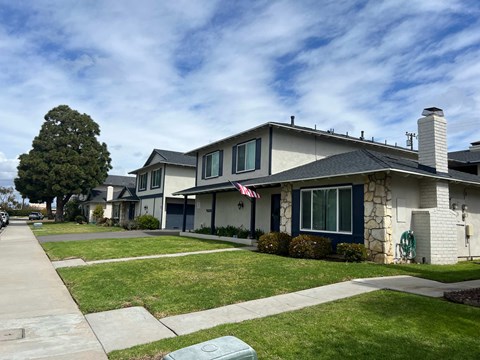 A house with a grey roof and a flag on it.