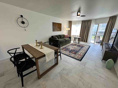 A living room with a dining table and chairs.