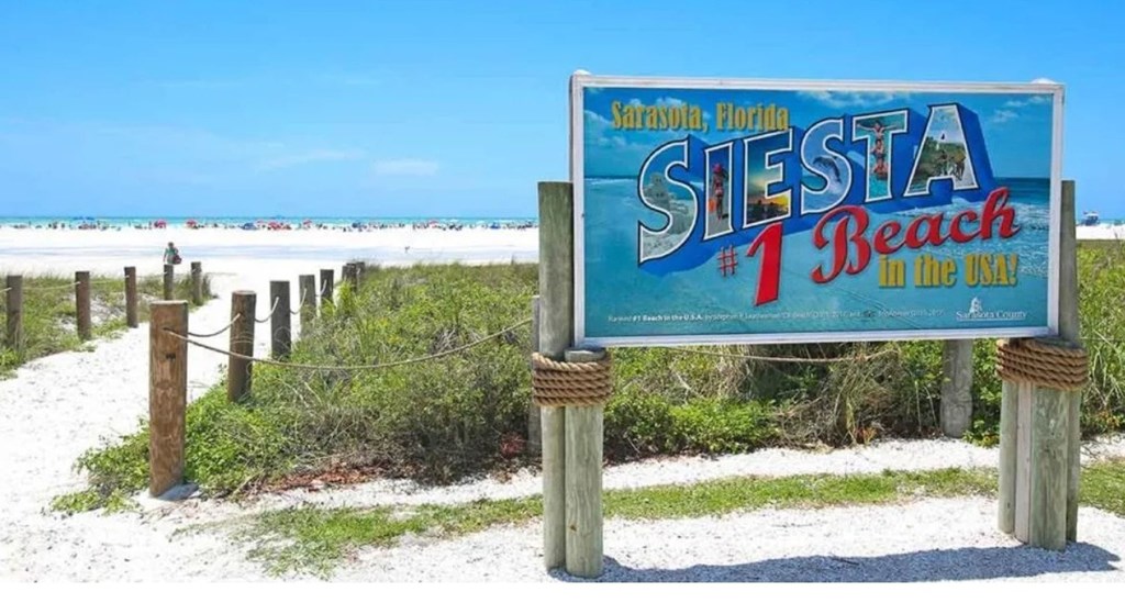 A sign that says Siesta Beach in the USA.