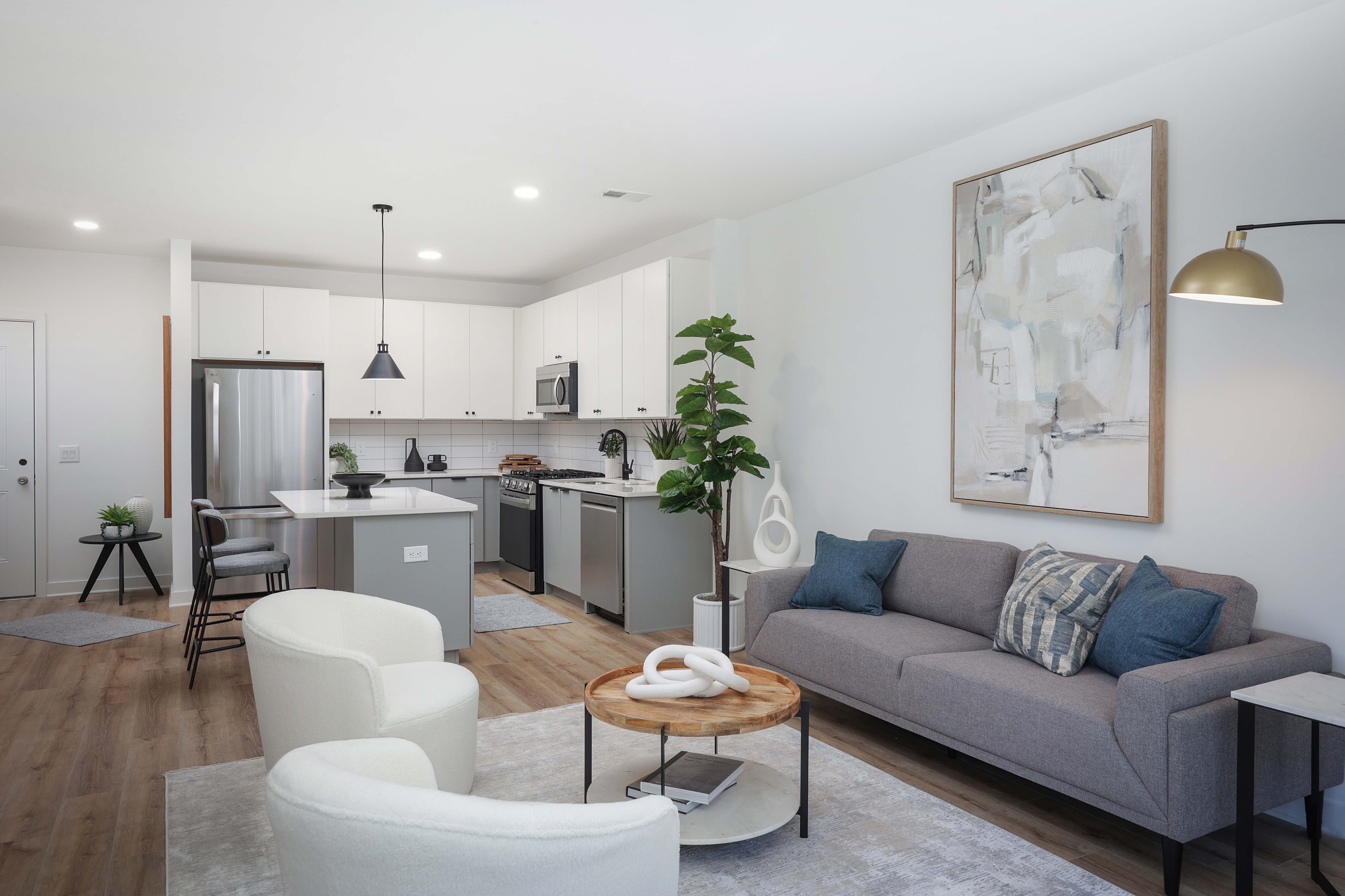 A modern living room with a grey couch and a wooden coffee table.
