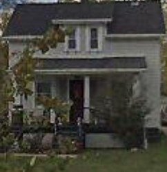 A house with a red door and a porch.