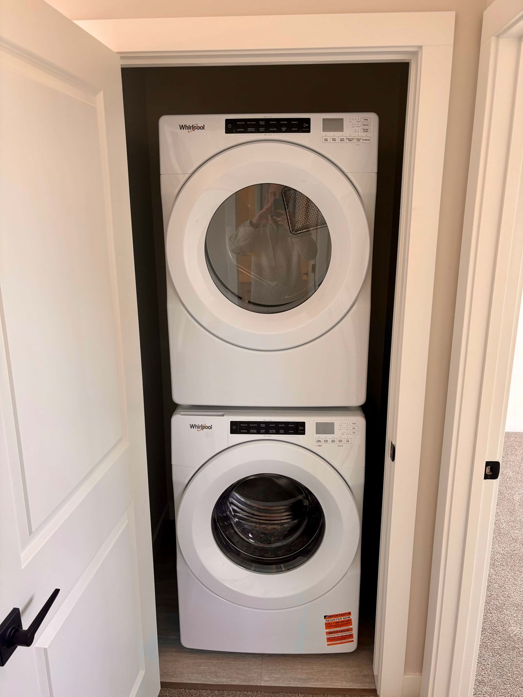 A white washing machine and dryer in a small laundry room.