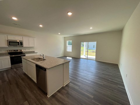 A kitchen with a sink and a window.