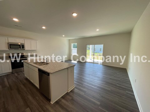 A kitchen with white cabinets and a countertop is shown.
