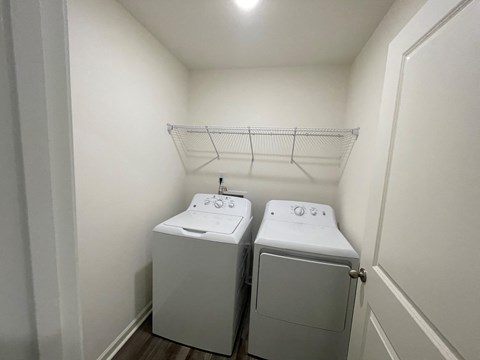 A small laundry room with a washer and dryer.