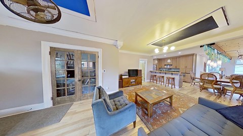 A living room with a blue chair and a television.