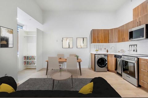 A modern kitchen with a dining table and chairs.