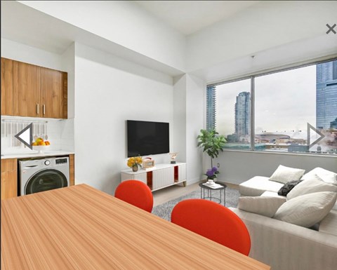 A modern living room with a wooden table and a television.