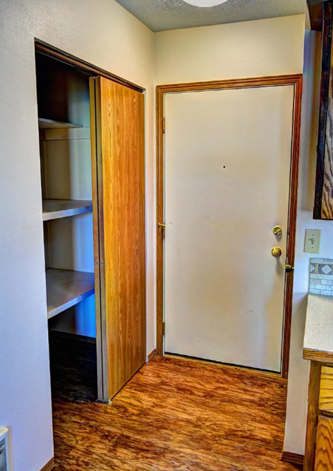 A white door is open to a hallway.