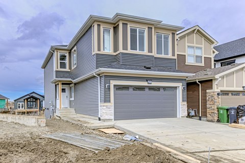 A house under construction with a grey garage door.