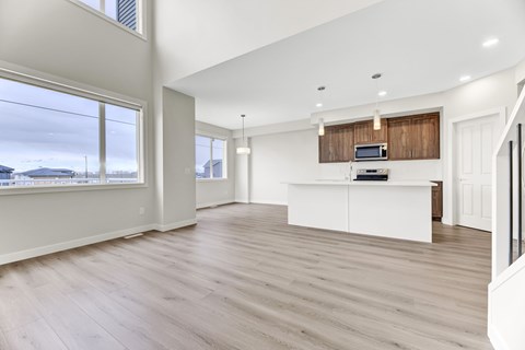 A spacious living room with a white cabinet and a television on the wall.